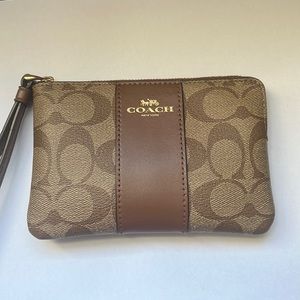 Used like new Coach Corner Zip Wristlet In Signature Canvas. Authentic.